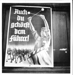 Photograph of a Nazi propaganda poster handing on a building in Munich, Germany, 1937 by Thomas F. Lambert