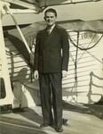 Photograph of Thomas F. Lambert posed in front of a life boat, circa 1937 by Elaine Barnett Photos