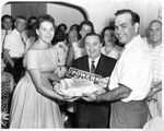 John Joseph Moakley and Evelyn Moakley presenting John E. Powers with a birthday cake, 1955 by unknown