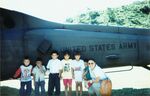 Gladys Rodriguez with children in front of helicopter in El Salvador, November 1997 by unknown