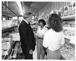 Public relations photograph in supermarket of John Joseph Moakley and staffer Deborah Spriggs (#3), 1980s by unknown