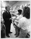 Public relations photograph of John Joseph Moakley and staffer Deborah Spriggs in a supermarket, 1980s by unknown