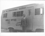 Congressman John Joseph Moakley standing in front of his mobile District office van, 1970s by unknown