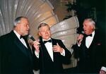 John Joseph Moakley (left), William Bulger (center, holding microphone) and unidentified man (right, holding microphone), singing at Moakley's Silver Jubilee event by unknown