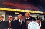 John Joseph Moakley (behind podium) and William Bulger (third from left) at Moakley's Silver Jubilee event by unknown