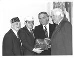 John Joseph Moakley receives the Annual Legislative award from the Department of Massachusetts American Legion, photographed with Thomas P. "Tip" O'Neill and two veterans, 1980s-1990s by unknown