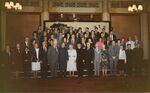 Members of a 1983 congressional delegation to China gather in front of mural by unknown